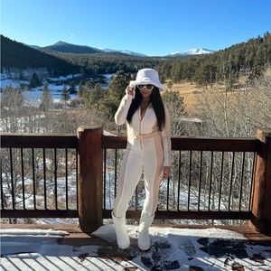 Tan and white ski suit.